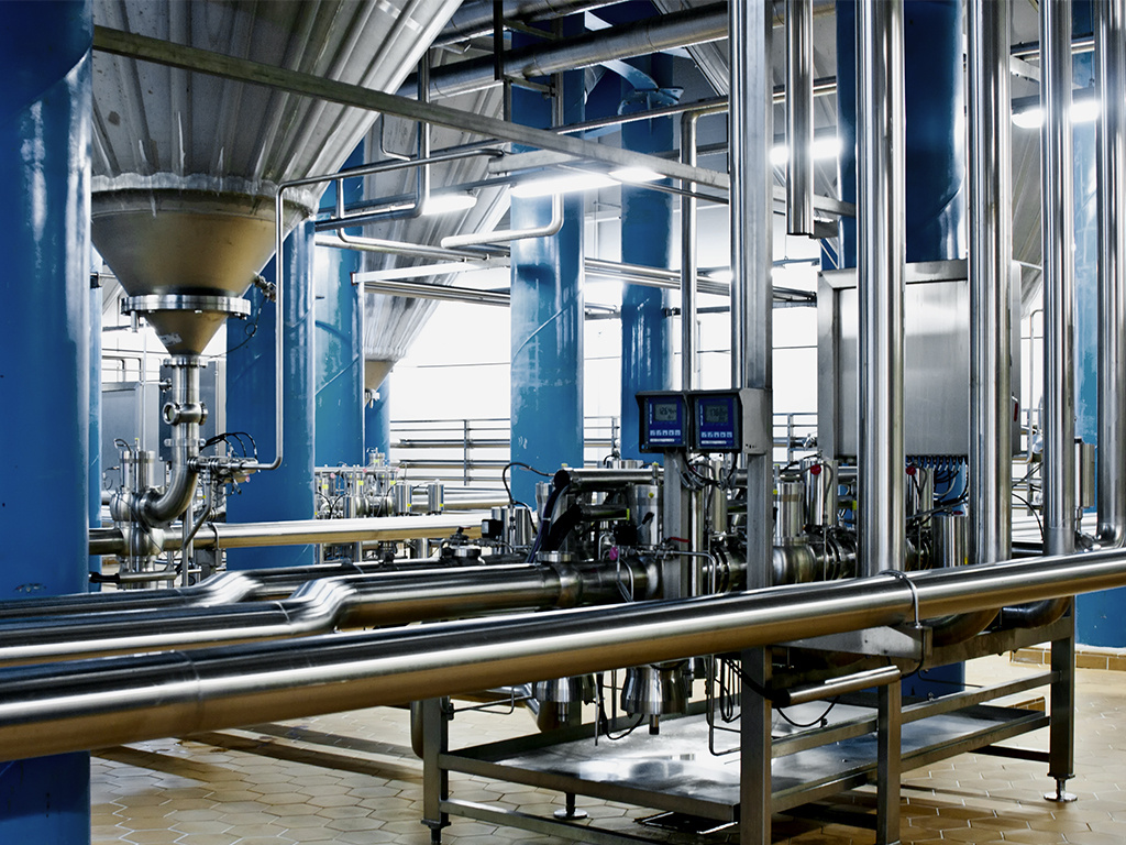 Large brewery floor with tanks and pipes