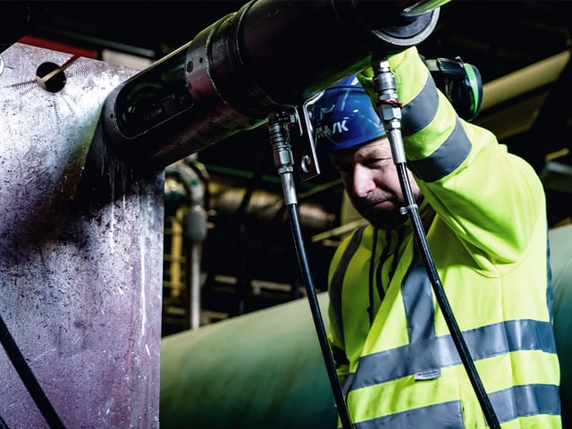 Service technican auditing pipes